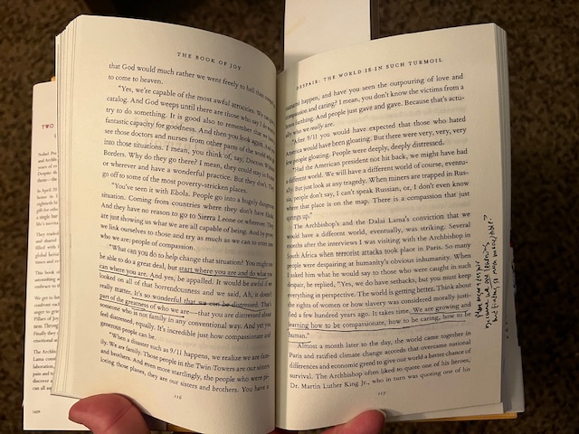 The Book of Joy open to pages 116 and 117, passages underlined and notes in right side margin. 