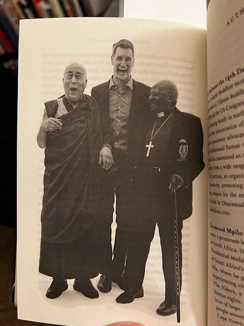 Picture of the Dalai Lama, Douglas Abrams, and Archbishop Desmond Tutu, all laughing. 